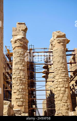 Process of restoration of columns in Great Hypostyle Hall at Temples of Karnak (ancient Thebes). Ancient Egyptian hieroglyphs and symbols carved on co Stock Photo