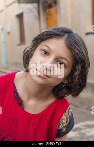 KHIVA, UZBEKISTAN - APRIL 25, 2018: Young local girl in the old town of Khiva, Uzbekistan. Stock Photo