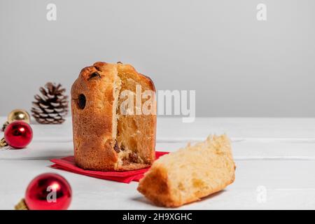 Italian dessert mini panettone surrounded by Christmas decorations on white background with copy space. Christmas or new year pastry food concept Stock Photo