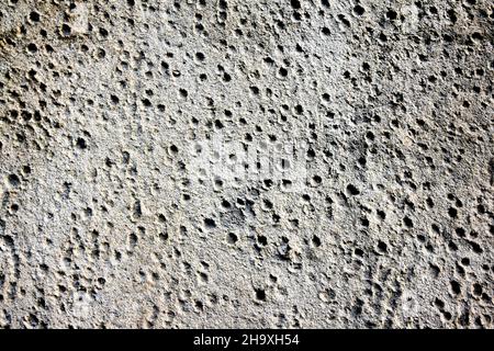 Concrete wall with small holes in black and white. Stock Photo