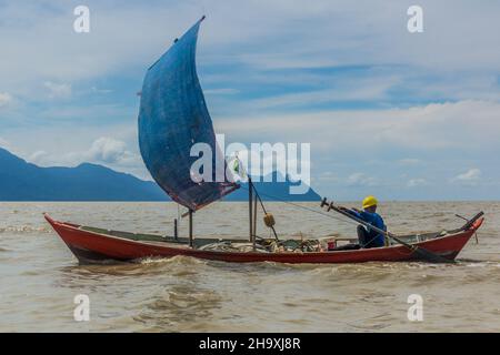 BAKO, MALAYSIA - MARCH 6, 2018: Small sailboat near Bako national park on Borneo island, Malaysia Stock Photo