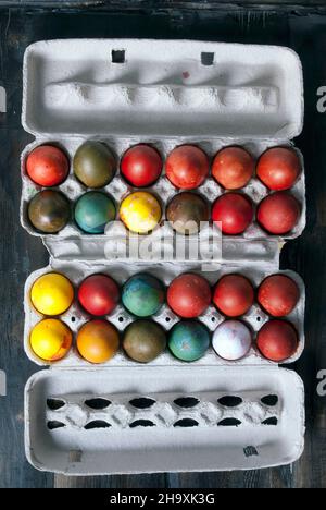 Naturally dyed eggs in an egg box for Easter Stock Photo