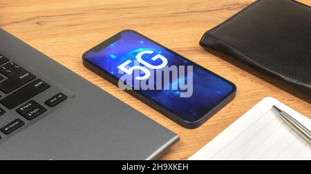 Phone with 5G network, hologram background. Business desktop. Concept of high speed internet, new generation of networks Stock Photo