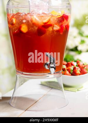 fruit punch in a drink dispenser at a party Stock Photo - Alamy