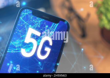 Phone with 5G network. Business desktop background. Concept photo of high speed internet, new generation of networks, data and connection, hologram on Stock Photo