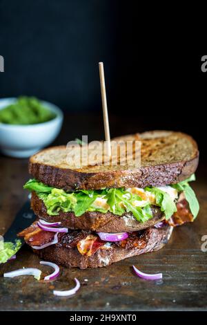 A grilled sandwich with vegetables, egg and bacon Stock Photo