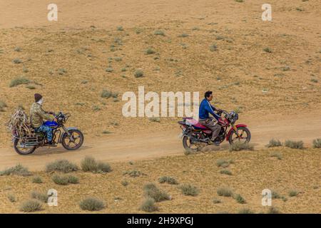 DARVAZA, TURKMENISTAN - APRIL 19, 2018: Motorcycle riders near Darvaza Derweze gas crater in Turkmenistan Stock Photo