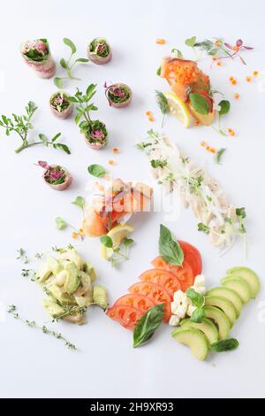 Various canapés with salmon, vegetables and herbs Stock Photo