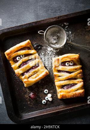 Halloween individual cherry pie mummies with edible eyes Stock Photo