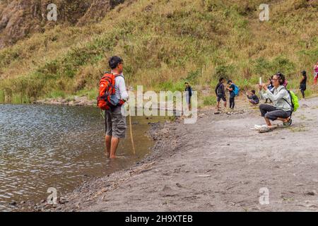 MT PINATUBO, PHILIPPINES - JAN 30, 2018: Tourists taking photos at the lake Pinatubo, summit crater lake of Mount Pinatubo volcano, Philippines Stock Photo