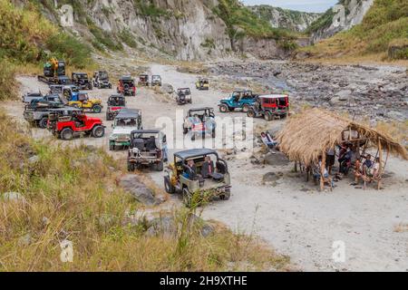 MT PINATUBO, PHILIPPINES - JAN 30, 2018: Tourist vehicles on a lahar mudflow remnant at Pinatubo volcano. Stock Photo
