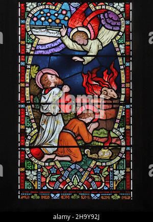 A stained glass window by Frederick Preedy, The Angel intervenes to prevent Abraham sacrificing Isaac, St Mary's Church, Old Hunstanton, Norfolk Stock Photo