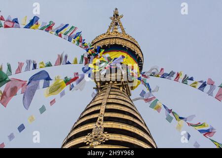 Buddhist prayer flags on the main stupa in the Swayambhunath temple complex in Kathmandu, Nepal. Stock Photo