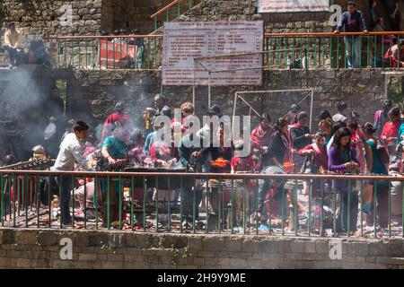 Hindu worshippers at the Dakshinkali Temple light butter lamps as part of their worship.  Pharping, Nepal. Stock Photo