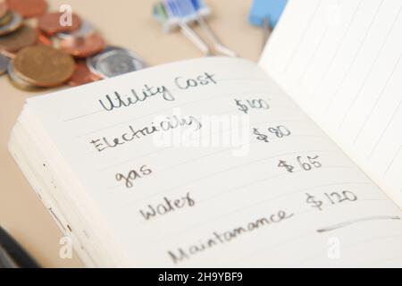 list of utility bills on a paper on table  Stock Photo