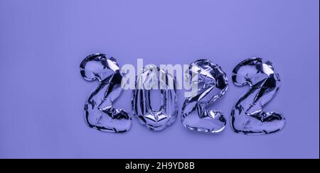 Foil balloons in form of numbers 2021 on pink background Stock Photo