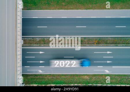 Driving on open road at beautiful sunny day to new year 2022. Aerial view Stock Photo