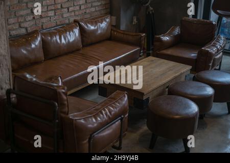 Interior of cafe brown colours.Wool table, Leather brown sofa and chairs in antique style. High quality photo Stock Photo