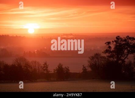 Winter Sunrise with Windsor castle emerging from mist on horizon Stock Photo