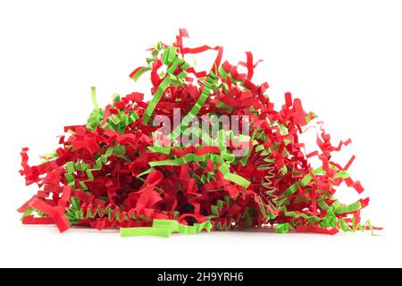 Red and green festive holiday confetti on a white background. Stock Photo