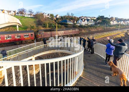 Vintage Class 47 diesel locomotive on an enthusiast special charter passing enthusiasts on Gypsy Bridge at Chalkwell, Essex, UK. Waving public