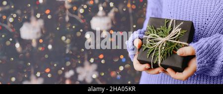 Female hands holding gift box. Christmas and New Year holidays concept. Banner Stock Photo