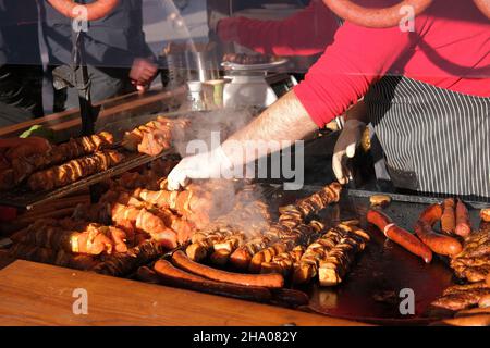 Open air grill restaurant with large selection of grilled gourmet meats and sausages, marinaded meat for grilling In a counter display, grill shop Stock Photo