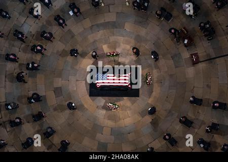 Elizabeth Dole lays across the casket of her husband, former Sen. Bob Dole, R-Kan., as he lies in state in the Rotunda of the U.S. Capitol, Thursday, Dec. 9, 2021, on Capitol Hill in Washington. Credit: Andrew Harnik/Pool via CNP Stock Photo