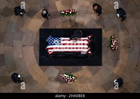 Elizabeth Dole lays across the casket of her husband, former Sen. Bob Dole, R-Kan., as he lies in state in the Rotunda of the U.S. Capitol, Thursday, Dec. 9, 2021, on Capitol Hill in Washington. Credit: Andrew Harnik/Pool via CNP Stock Photo