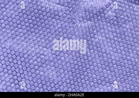 Color of the year 2022 very peri. Clear bubble foil for wrapping. Close up, texture background, trendy colors and pollution concept Stock Photo