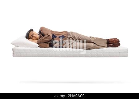 Senior man sleeping on a floating matress isolated on white background Stock Photo