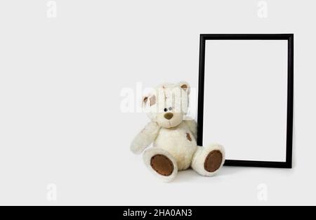 White soft toy bear with vertical frame mockup with copy space. Empty space. Stock Photo