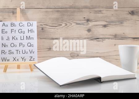 Book opened on a workspace. White pages for inscriptions. Stock Photo