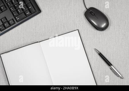 Book opened on a workspace. White pages for inscriptions. Stock Photo