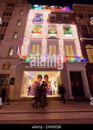 London, Greater London, England, December 04 2021: Stella McCartney fashion store on Old Bond Street with a Christmas display at night. Stock Photo