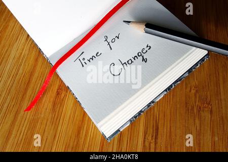 Small notebook and a pencil on wooden background Stock Photo