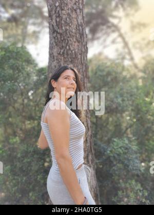 Happy  spanish  middle-aged woman posing in the forest Stock Photo