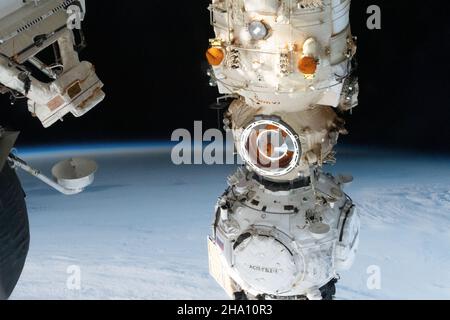 International Space Station, Earth Orbit. 04 December, 2021. The Moon's shadow, caused by a solar eclipse over Antarctica, seen from the International Space Station as it orbits 269 miles above the south Atlantic Ocean December 4, 2021 in Earth Orbit. In the foreground, is the Russian Prichal module attached to the Nauka multipurpose docking module. Credit: NASA/NASA/Alamy Live News Stock Photo