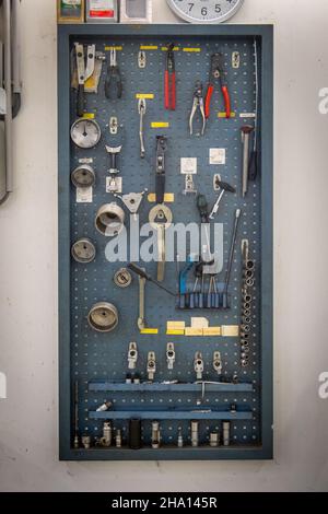 in a garage there are many tools hanging on the wall Stock Photo