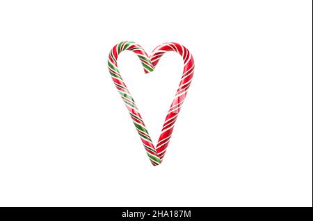Heart made of candy canes on white background Stock Photo