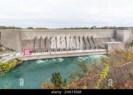 Large dam for electricity generation along a river on a cloudy autumn day Stock Photo