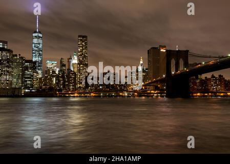 View of Lower Manhattan, the World Trade One building and the surrounding Brooklyn Bridge, as seen from Brooklyn, near the D.U.M.B.O. Stock Photo