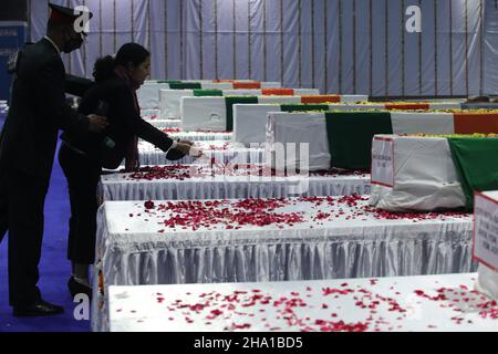 New Delhi, India. 09th Dec, 2021. A family member pays her last respects next to the coffin of Brigadier LS Lidder who lost his life in an Indian Air Force (IAF) Mi-17V5 military helicopter crash a day ago in Coonoor area Tamil Nadu, during a tribute ceremony at Palam Air base Station in New Delhi. Credit: SOPA Images Limited/Alamy Live News Stock Photo