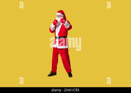 Santa claus yellow funky big, fat holiday christmas man aged, december people. Hat cheerful, celebrate in boxing gloves Stock Photo
