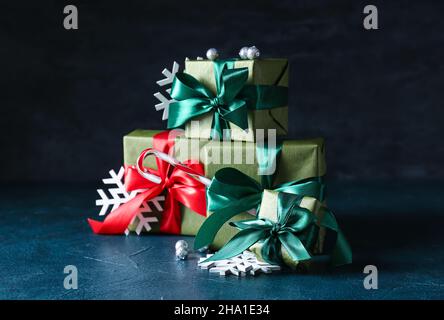 Christmas gift boxes and snowflakes on dark background Stock Photo