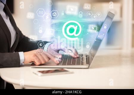 Hands working on laptop with digital icons concept Stock Photo