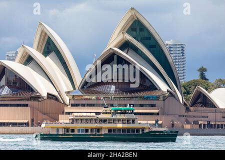 Emerald class ferry the MV May Gibbs on Sydney Harbour passes the Sydney Opera House, on a stormy summers day,NSW,Australia Stock Photo