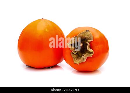 Two ripe persimmon fruits isolated on white background. Stock Photo