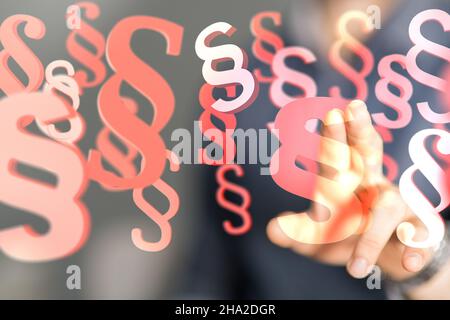 Man tapping on 3D rendered paragraph symbols - law and justice concept Stock Photo