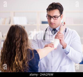 The traumatologist is taking care of the patient Stock Photo